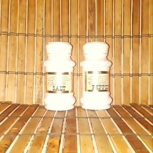Vintage white milk glass salt & pepper shakers with screw top lids and labels.